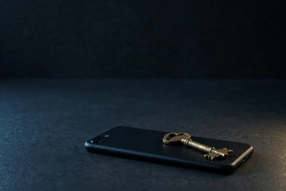 Brass key on a switched-off phone
